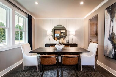 Dining area featuring ornamental molding and dark 