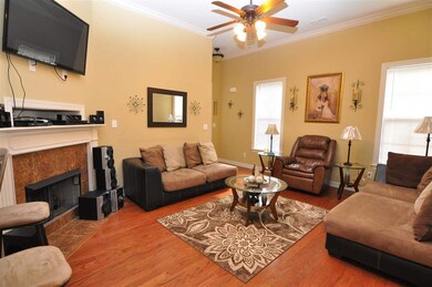 The great room features a neutral decor, high ceil