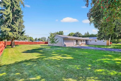 View of front facade with a fenced backyard, a patio area, and a garage