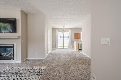Unfurnished living room featuring carpet floors, b