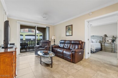 Living area with crown molding and light tile patterned floors