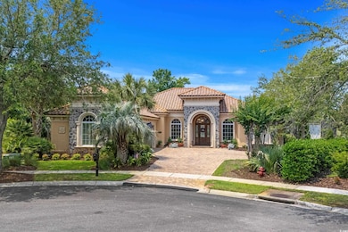 Mediterranean / spanish home with a tile roof and stucco siding