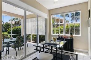 Sunroom / solarium with tile patterned floors and baseboards