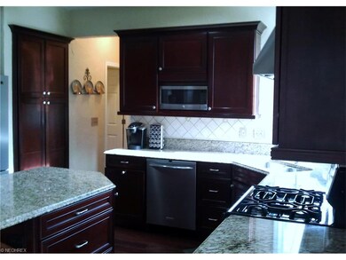 Beautiful custom kitchen with cherry cabinets and 