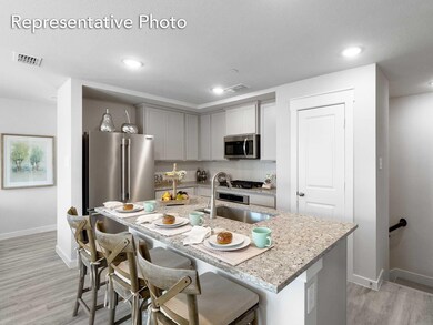 Kitchen featuring a kitchen island with sink, appliances with stainless steel finishes, sink, light hardwood / wood-style flooring, and a breakfast bar area