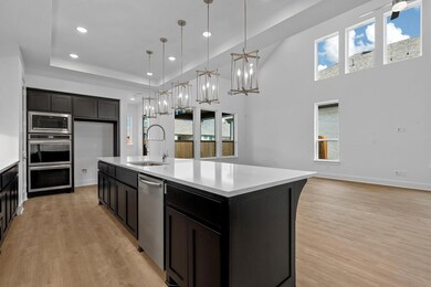 Kitchen featuring a sink, light countertops, ligh