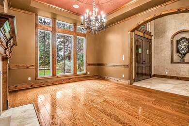 Elegant Formal Dining room immediately to the left when entering the home.  Double crown molding, custom ceiling & woodwork.  Oversized windows flood the home with natural light.