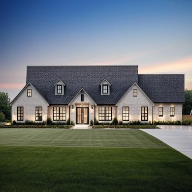 View of front of home featuring french doors, a lawn, and brick siding- final product may vary