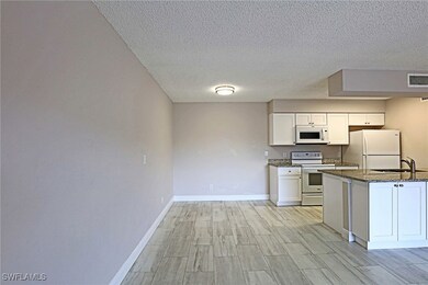 Kitchen featuring white appliances, white cabinetr