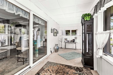 Sunroom / solarium featuring a porch