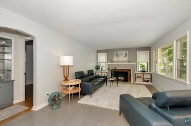 Living room featuring a fireplace and arched walkways