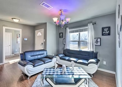 Living room with a chandelier and wood finished floors