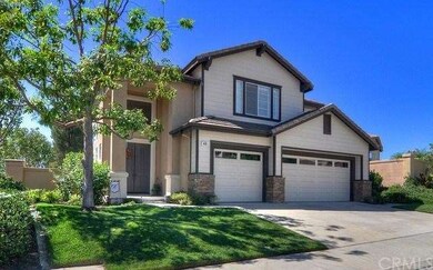 Drive up to the 3-car garage accented by brick pil