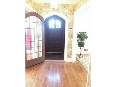 Foyer Front hallway with leaded glass door and arc