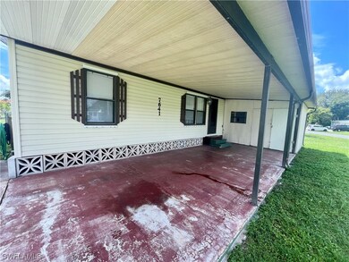 Carport with large attached shed.