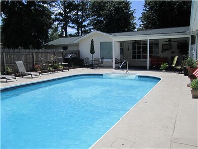 View from end of pool to patio area - fence around pool and large concrete area for sitting an relaxing by pool!