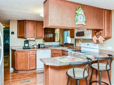 This wonderful kitchen boasts a peninsula that aff