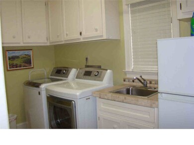 laundry room with room for refrigerator