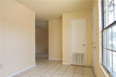 Unfurnished room with light tile patterned floors and a healthy amount of sunlight