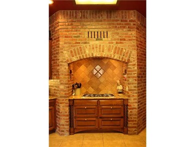 Kitchen. Gas Stove with custom brick hood and tile backsplash accents