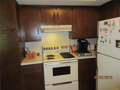 Kitchen with formica counter, vinyl floor, refrige