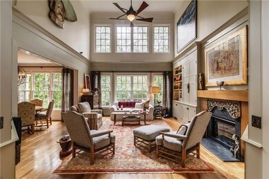 Light-filled,2-story family rm features floor-to-ceiling windows, gas log equipped, limestone fireplace w/teak mantle. Master crafted, custom cabinetry & bookcases display treasures, television & stereo.