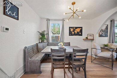 Dining area featuring light wood-style floors, arc