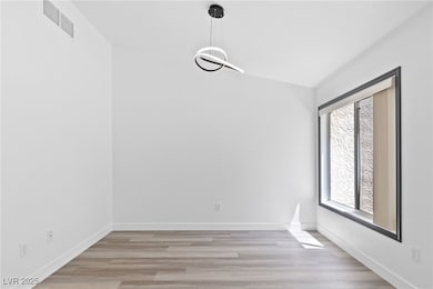 Unfurnished room featuring visible vents, a wealth