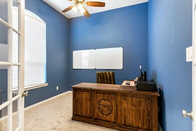 The Home Office has French doors, front yard views, window treatments, ceiling fan and high ceilings!