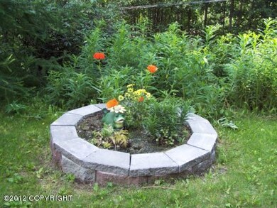 FLOWER BED BY FRONT DRIVEWAY
