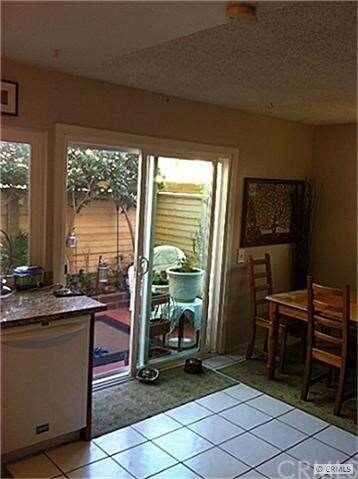 DUAL PANE VINYL SLIDER LEADING OUT TO PATIO FROM K