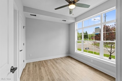 Unfurnished room with light wood finished floors and a ceiling fan