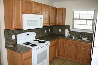 Kitchen has refrigerator and microwave.