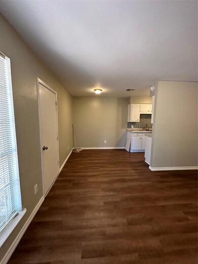 Unfurnished living room with baseboards and dark 