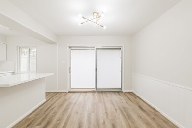 The dining room has luxury vinyl plank floors and