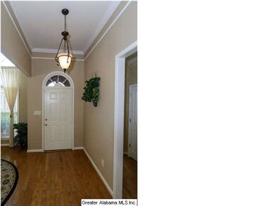 Beautiful entry way- gleaming floors, arch window 