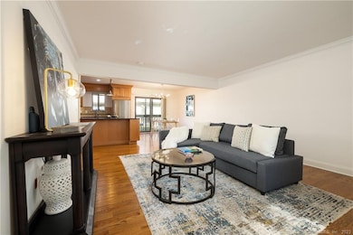 Open Concept living room, dining room and kitchen with sliders leading outside to the walk-off balcony