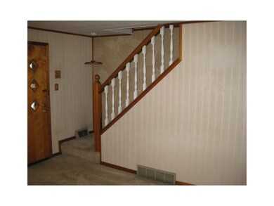 Living Room. Front door and stairs.