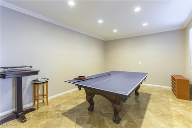 Playroom with crown molding and recessed lighting