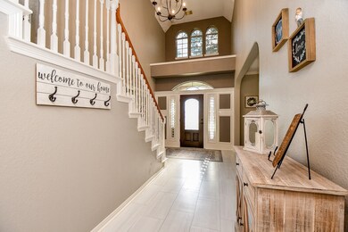 FOYER FEATURES NEW TILE FLOORING, FRESH NEUTRAL PAINT AND A STORAGE CLOSET WITH BUILT IN SHELVING UNDER THE STAIRS
