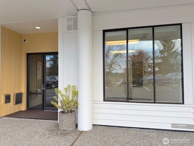 Suite 103 is to the right side of the lower floor lobby entrance with seating, and some of the other shared common areas including mail boxes, kitchenette, restroom, and the shower room are all close by.