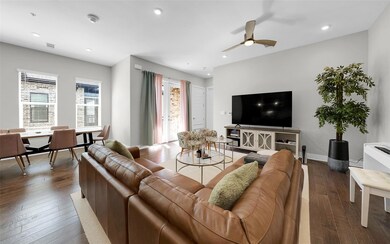 Living area featuring ceiling fan, hardwood / woo