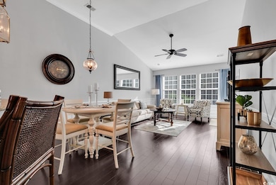 Dining room with dark hardwood / wood-style floori