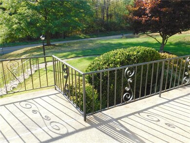 Stylish black wrought iron railing surrounds the b