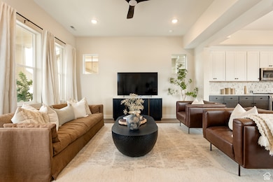 Living room featuring ceiling fan, recessed lighting, and light wood finished floors