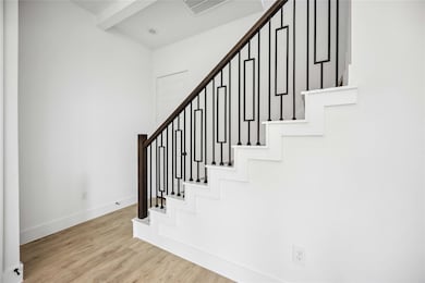 Tucked staircase with wrought iron design and lead