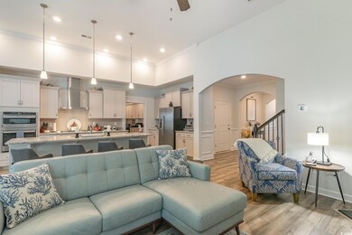 Living room featuring ceiling fan, light hardwood 