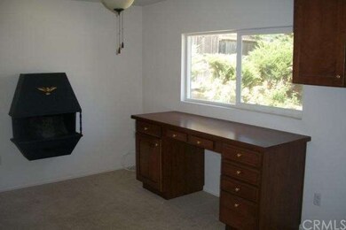 Office/bedroom with faux fireplace