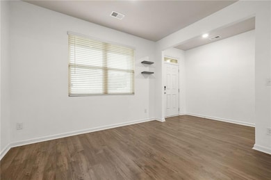 Unfurnished room featuring dark wood-style flooring and recessed lighting