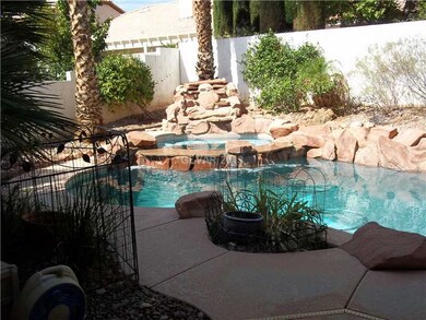 Exterior Back. POOL/SPA COMBO WITH WATERFALL